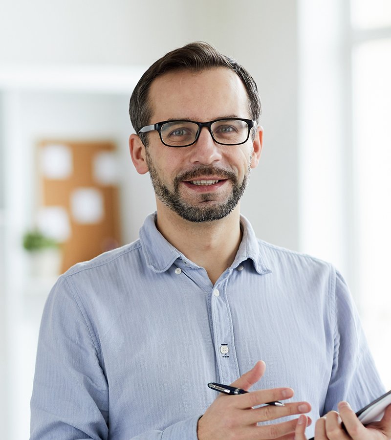Counselor taking notes during a one-on-one anger management session.